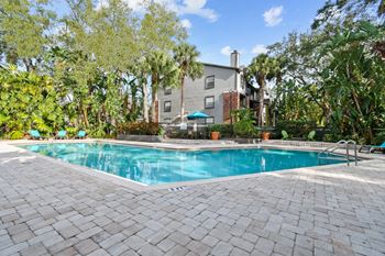a swimming pool with a house in the background